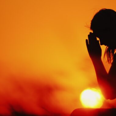 Silhouette of person praying